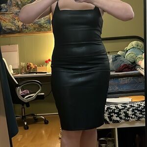 A maxi, black, bodycon, dress with animal print design.